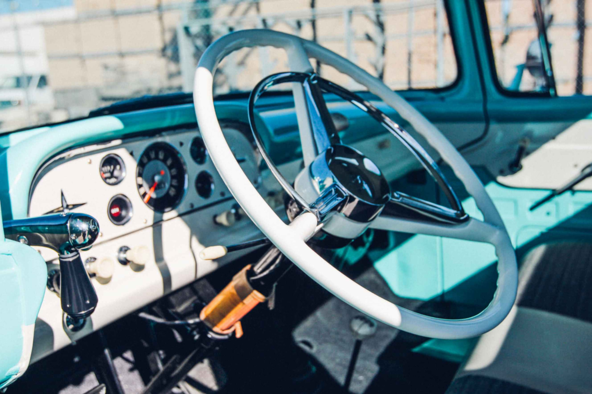 White steering wheel and polished dash in the turquoise cab