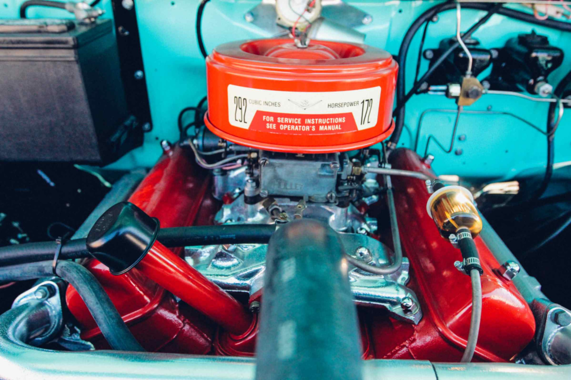 Engine bay from above with the chrome intake, Holley carburetor, and 292-cubic-inch air cleaner