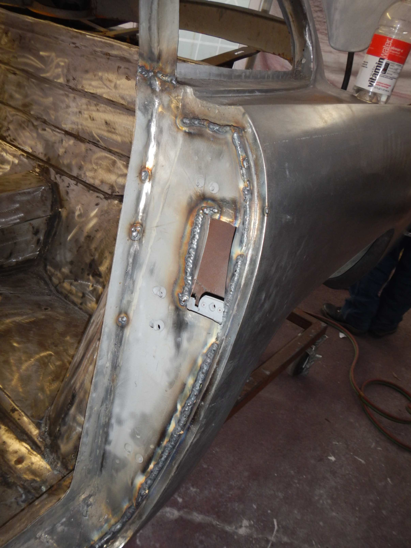 Welded door jamb and latch reinforcement