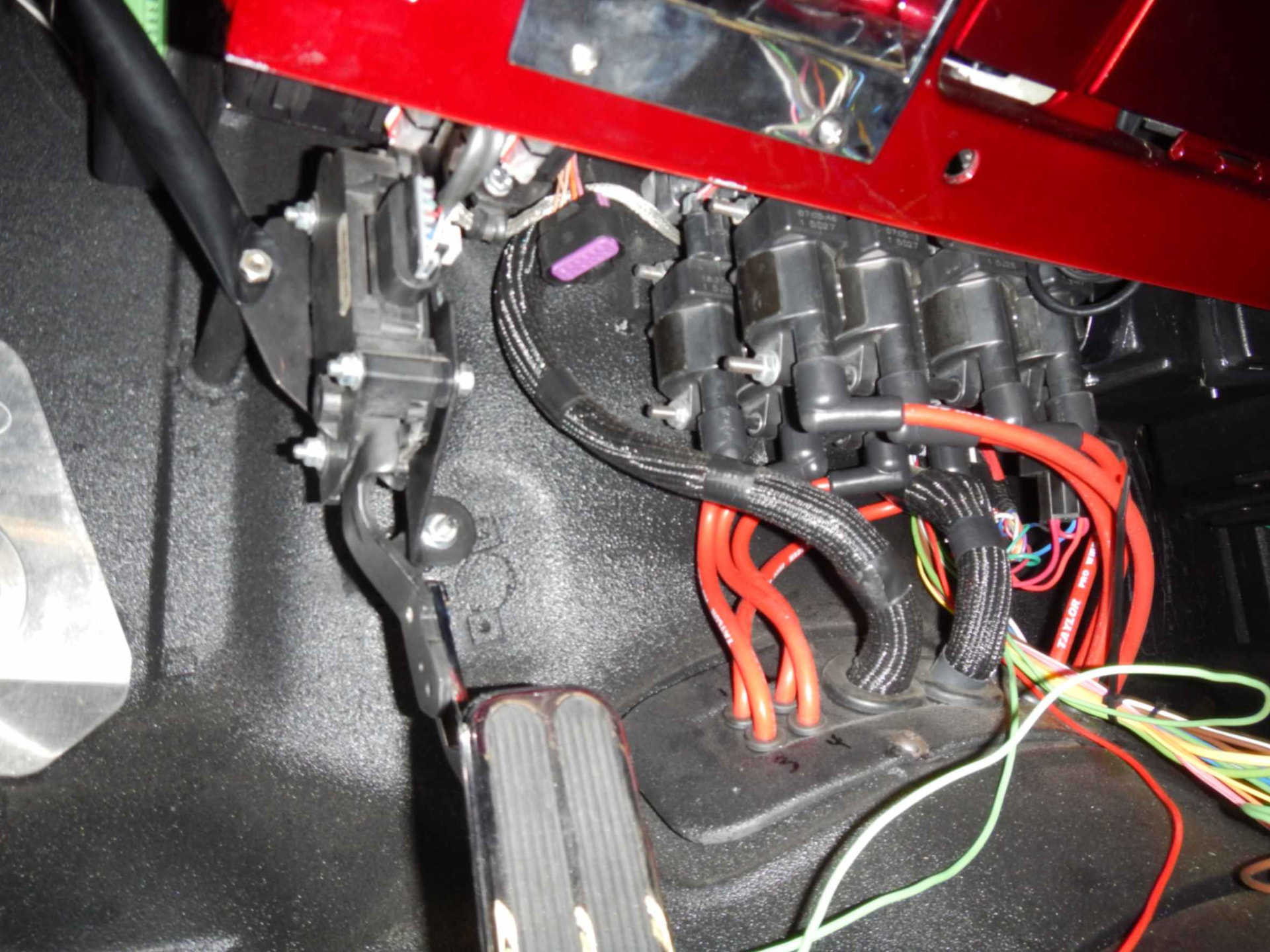 Ignition coils and under-dash wiring routed in the footwell