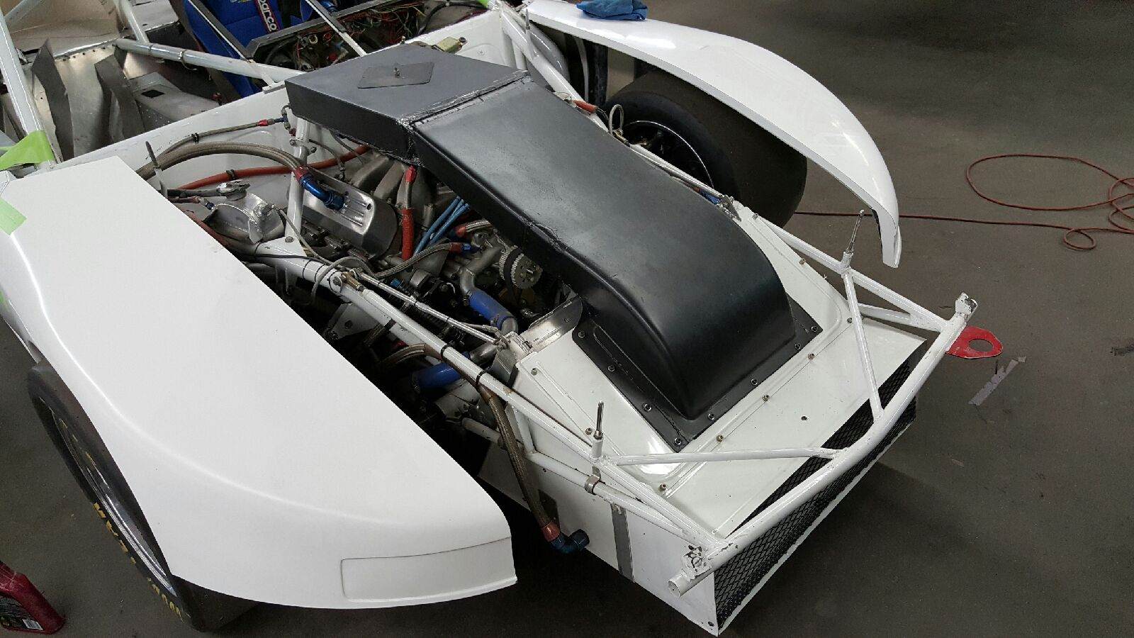 Engine bay and front bodywork during disassembly
