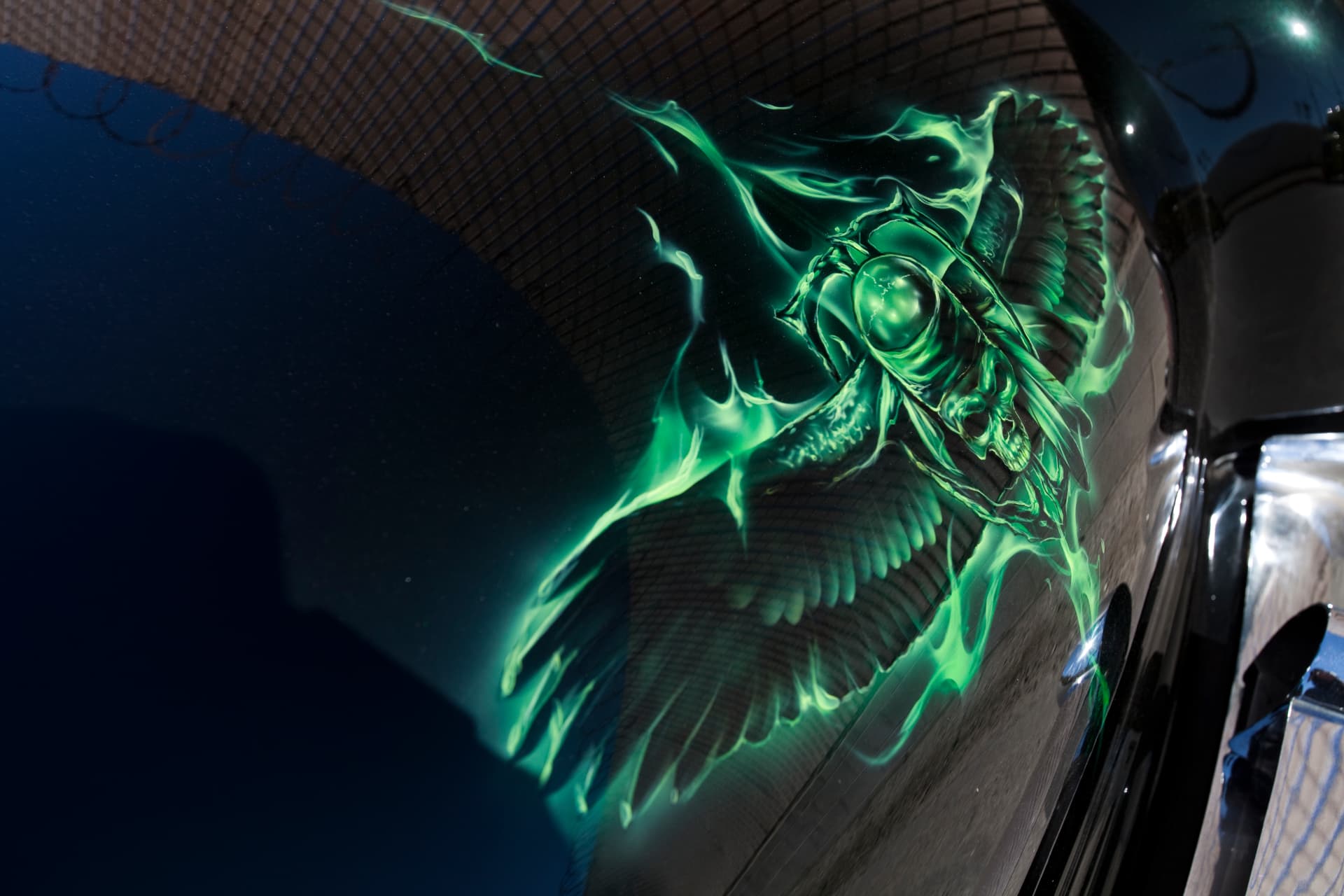 Winged skull mural airbrushed in green over black