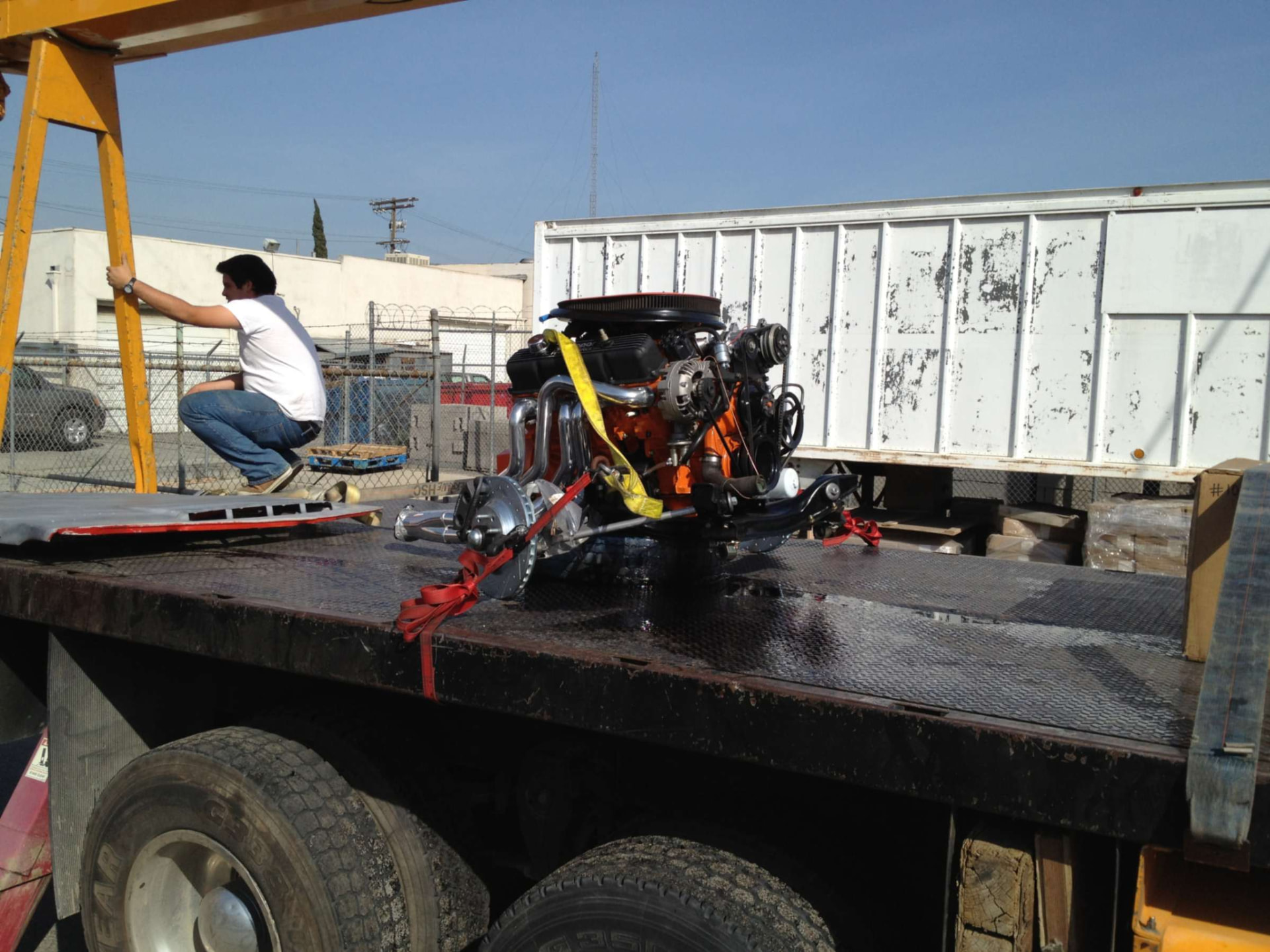 Orange V8 engine arriving at the shop for installation