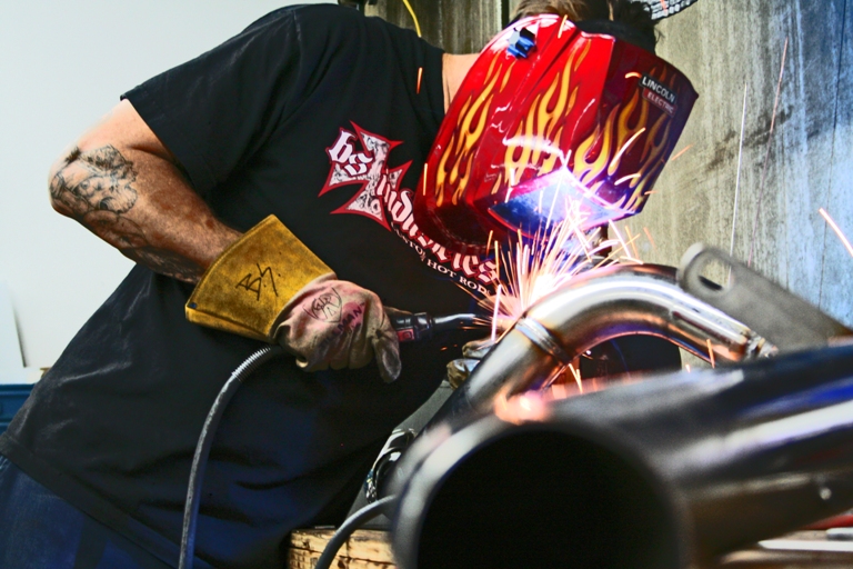 Bodie welding headers in the shop