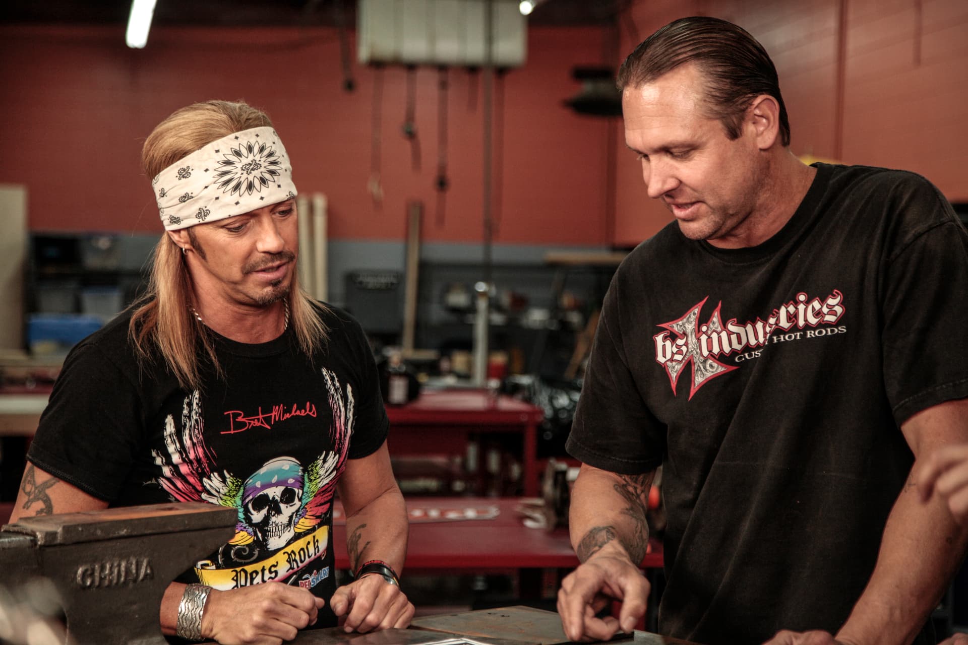 Bodie and Bret Michaels reviewing plans in the BSI shop