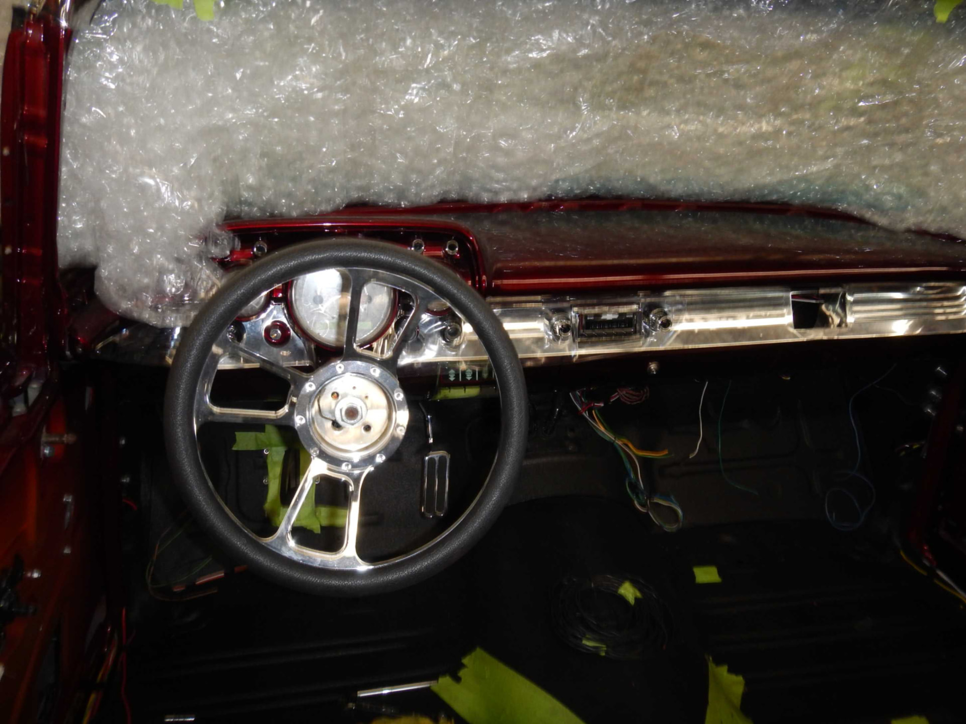 Dash and steering wheel in place while the interior wiring continues