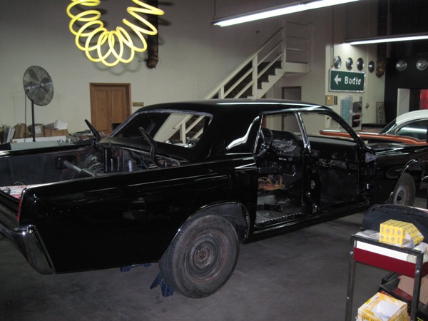 Body in black on the shop floor, doors and glass out
