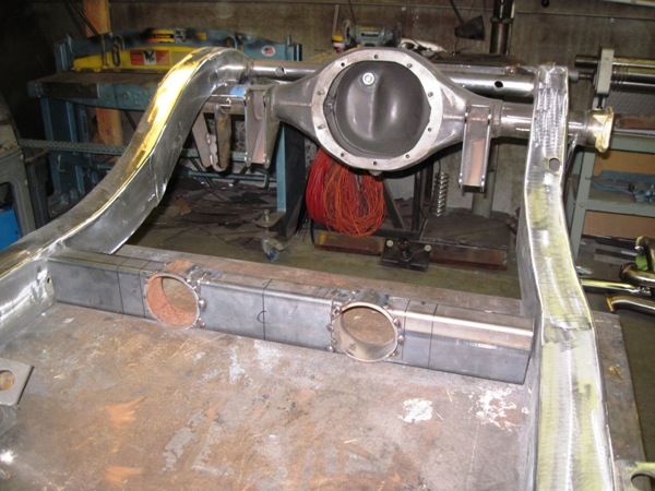 Hand-fabricated driveline tunnel and rear end on the chassis table