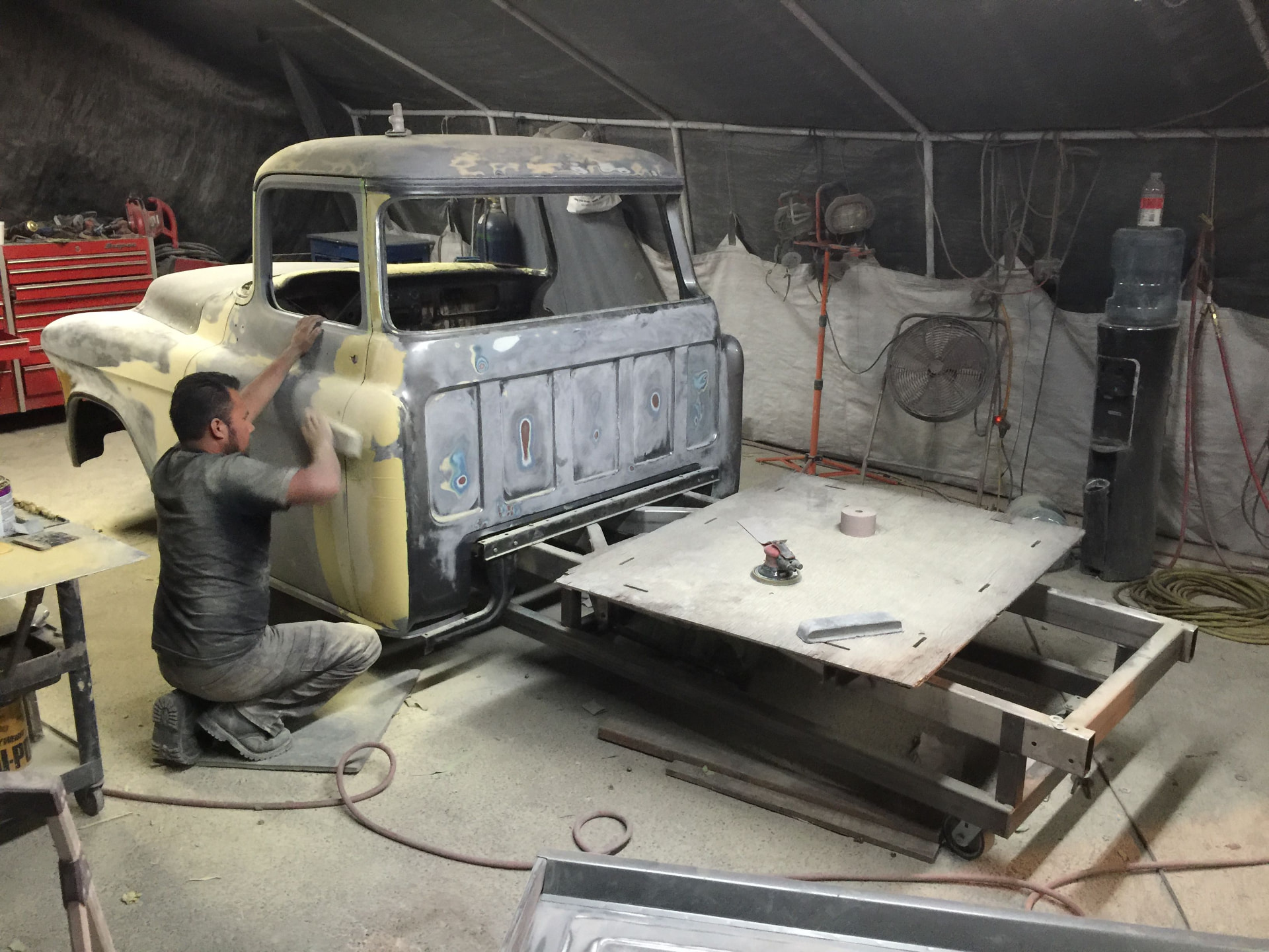 Hand-finishing bodywork in the tent shop