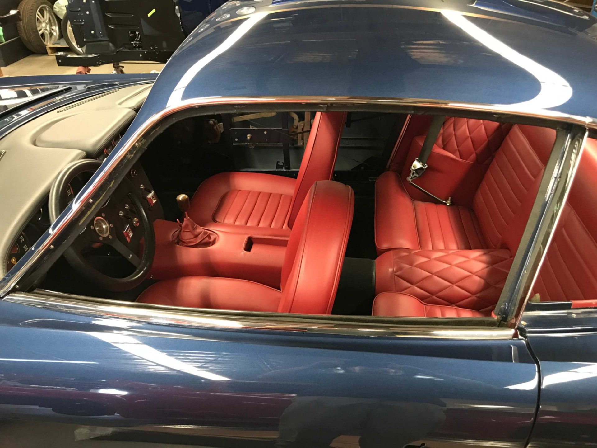 Red leather cockpit with steering wheel and shifter