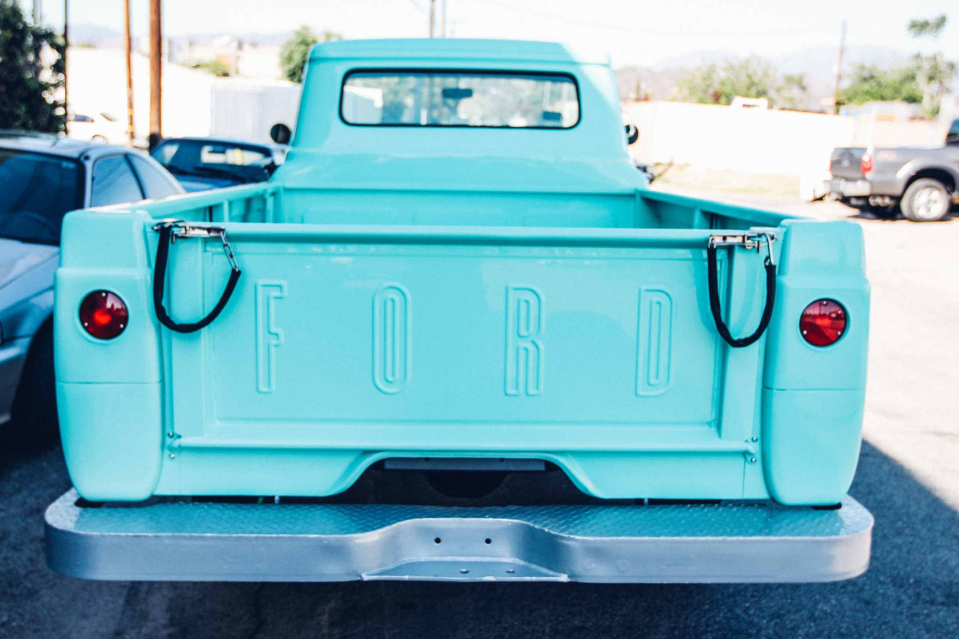 Tailgate with stamped FORD lettering and chrome chains