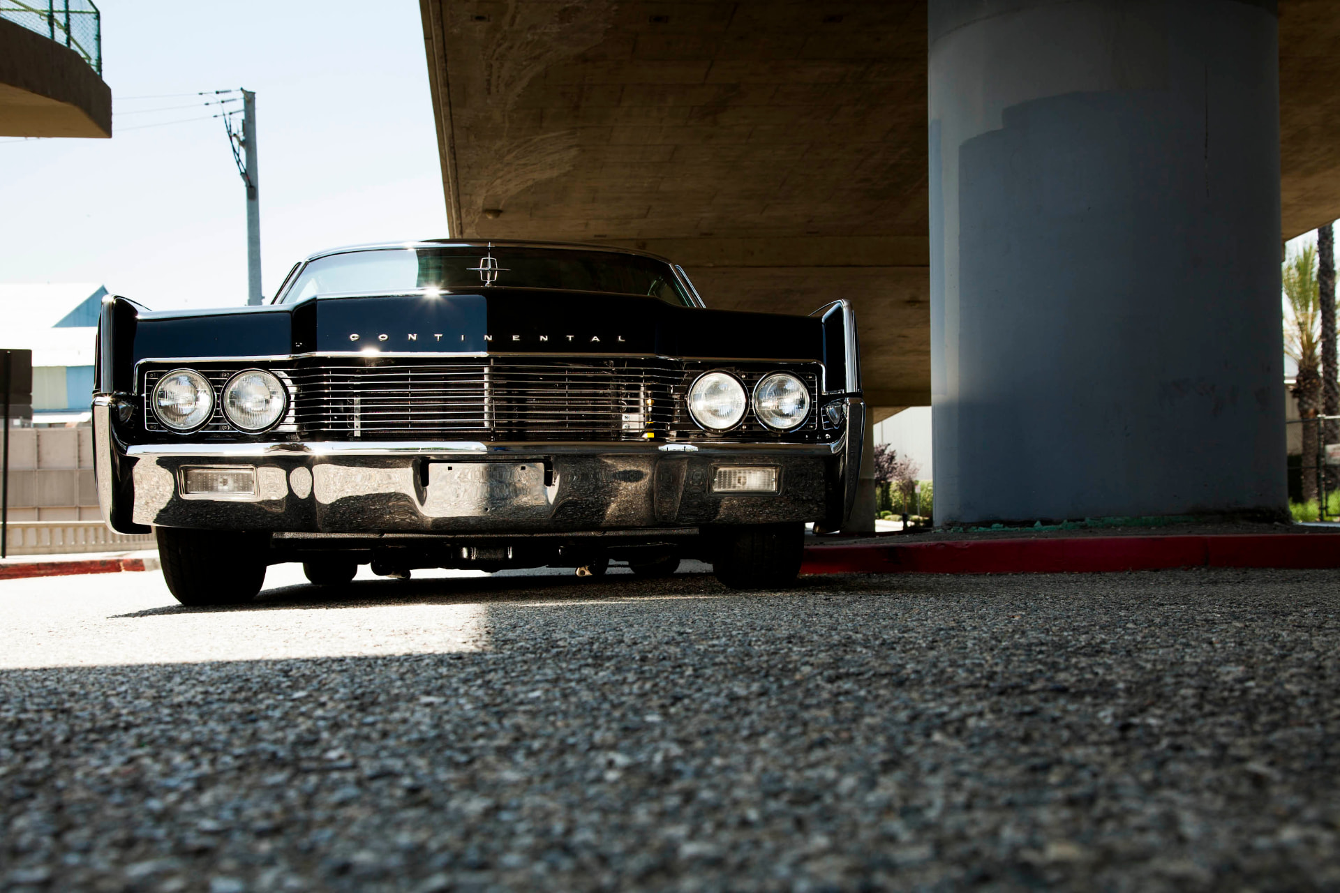 Low front three-quarter — full chrome grille and quad headlights