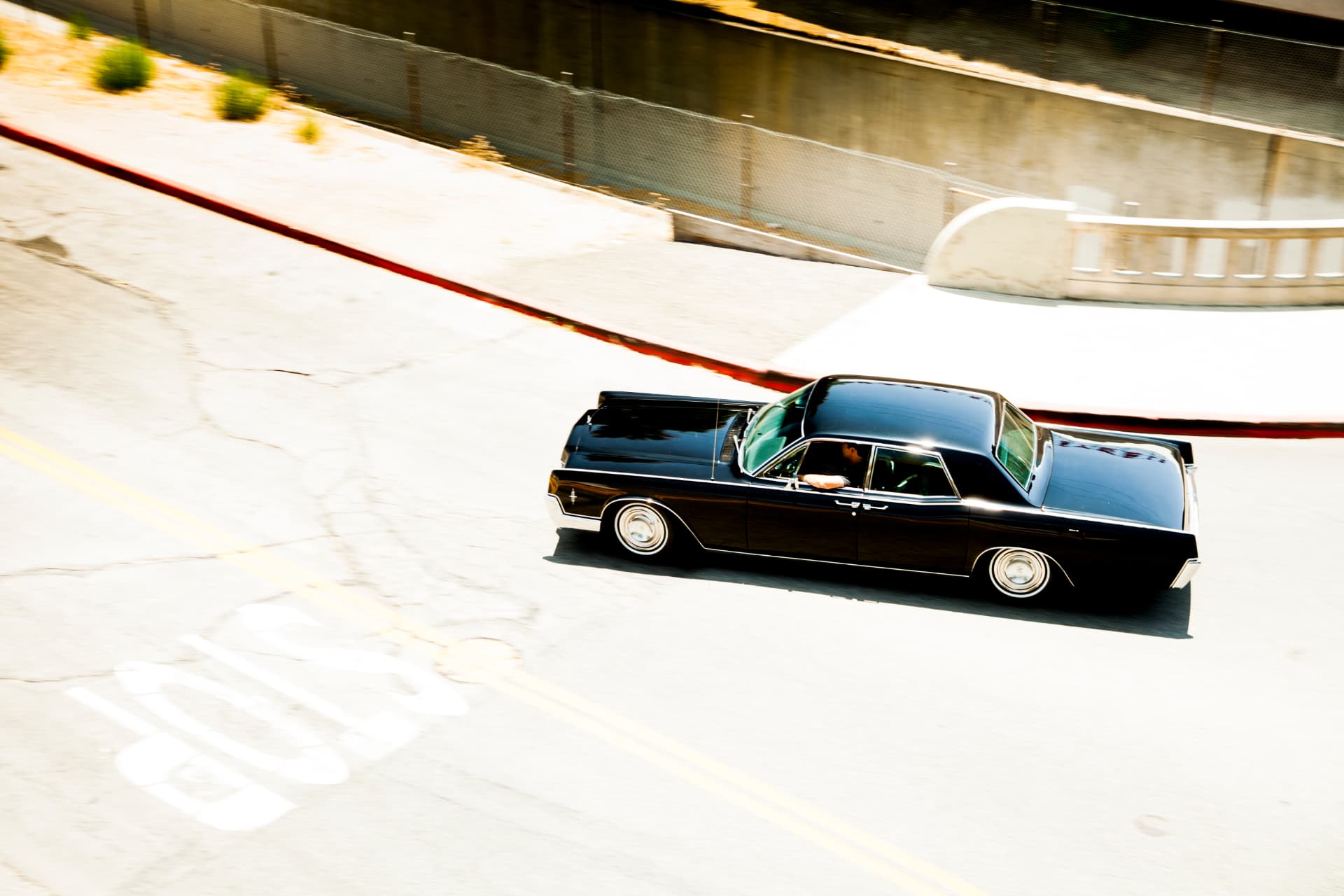 Rolling shot from above — slammed Continental carving through Burbank