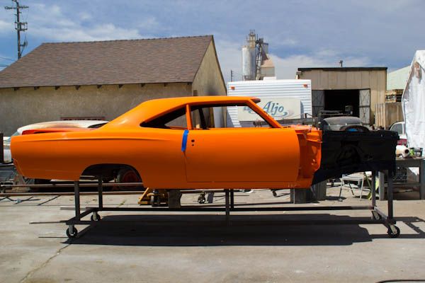 Freshly painted orange body shell on the build stand