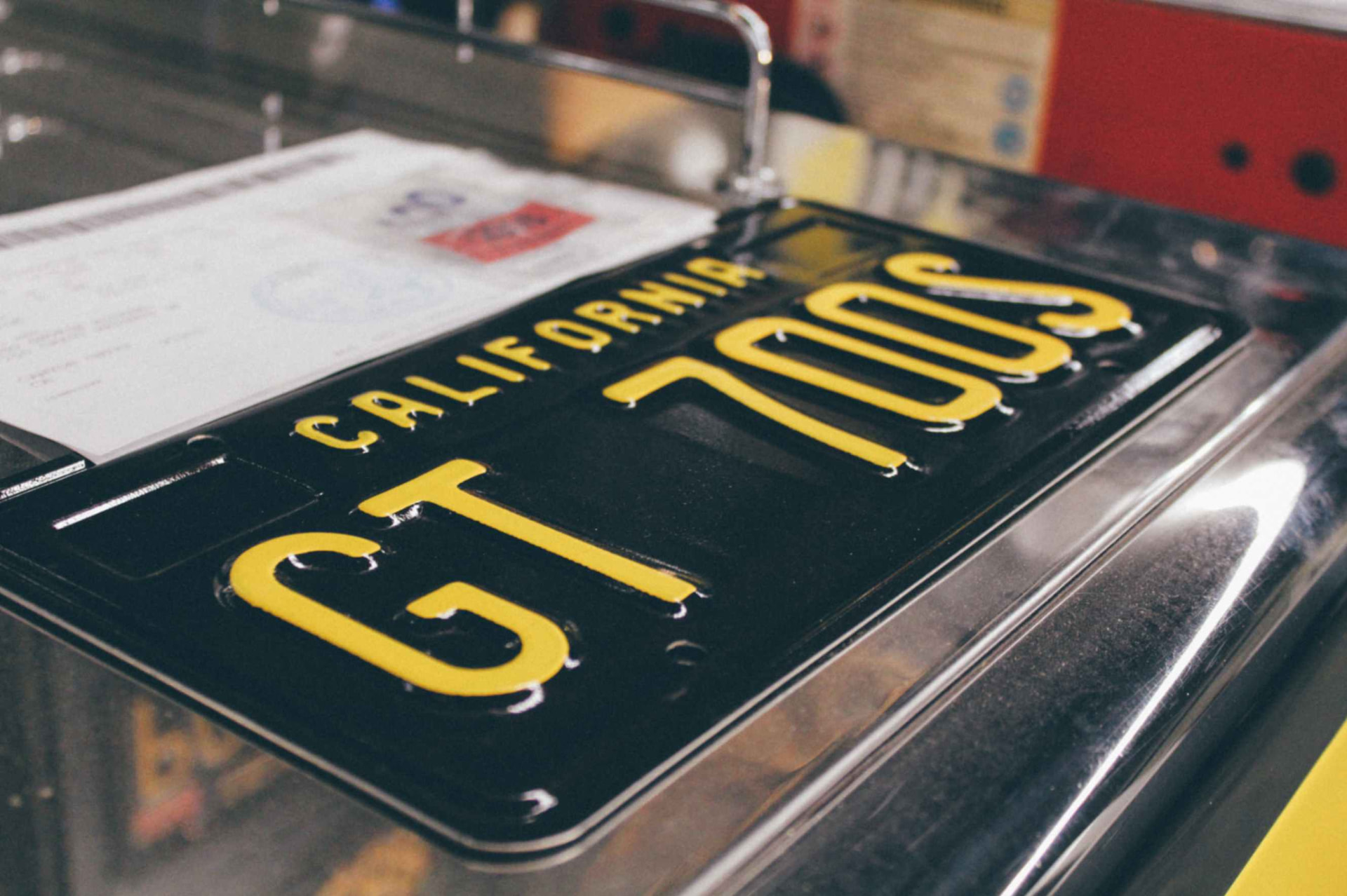 California GT 700S specialty plate resting on the cooler's polished chrome top