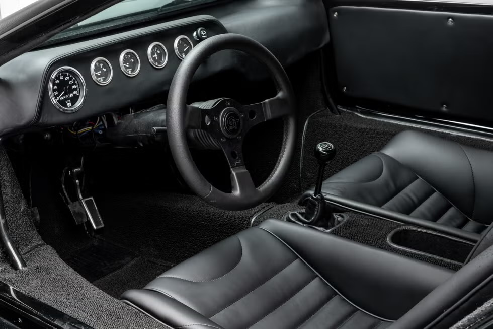 Finished Corwin cockpit, gauges, steering wheel, and black leather seats