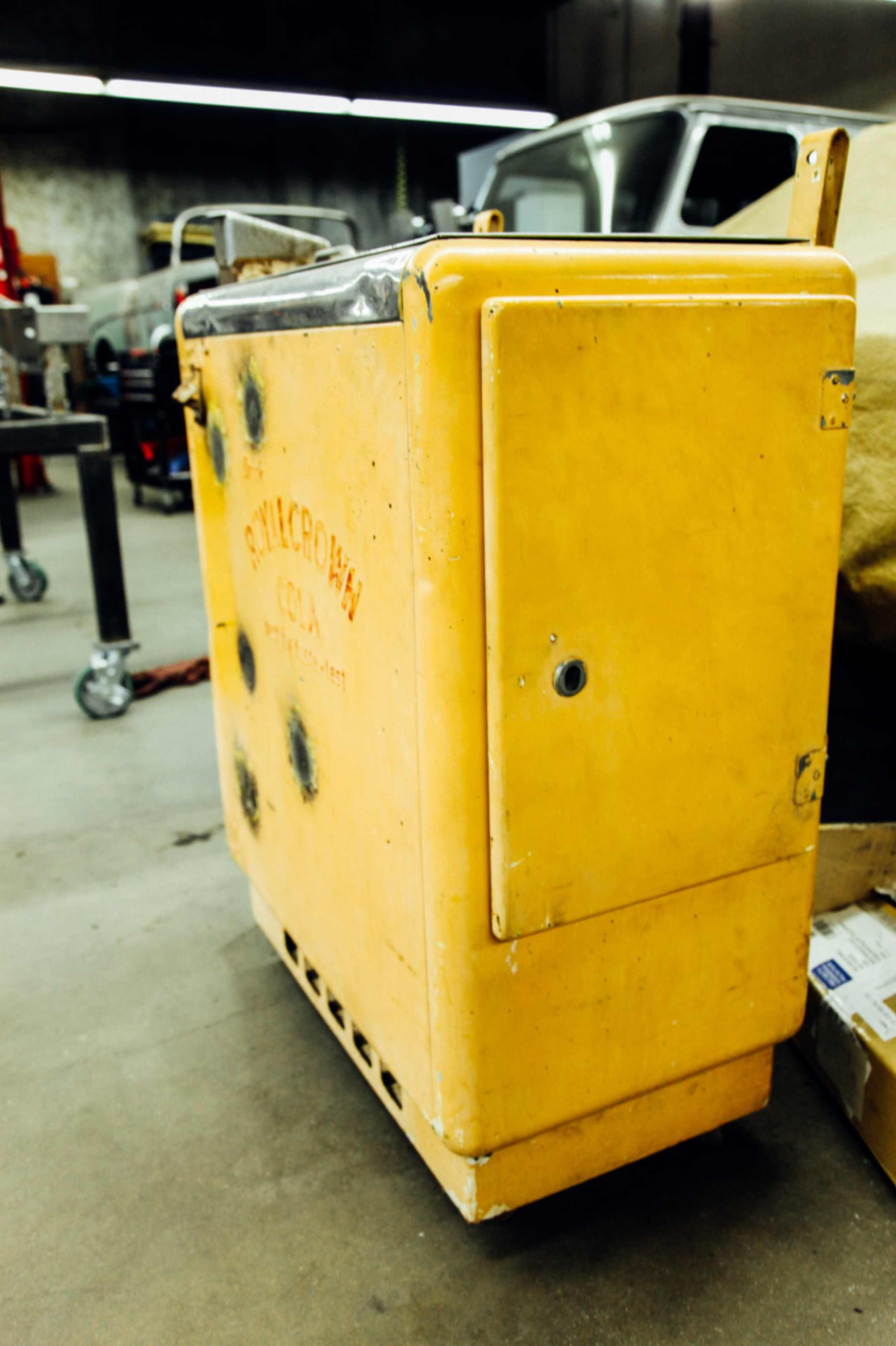 Bodywork in progress, grinder marks across the yellow front panel