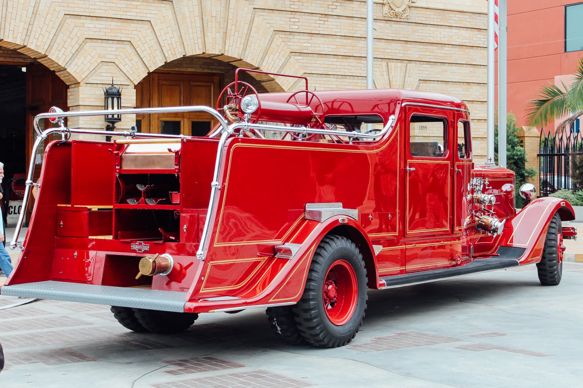 Rear three-quarter showing the hose bed, gold pinstriping and diamond-plate step