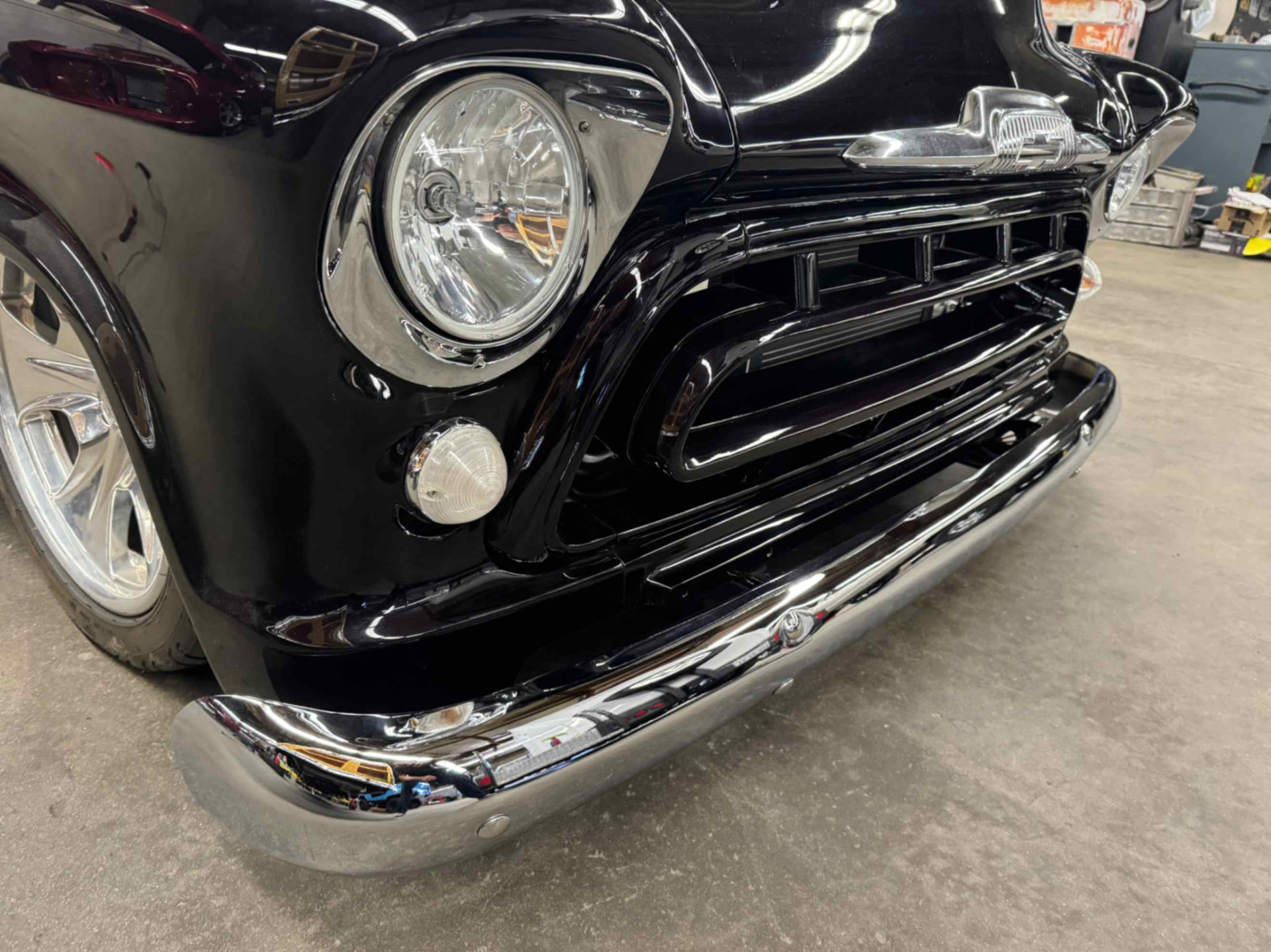 Headlamp and grille detail, glossy black finish